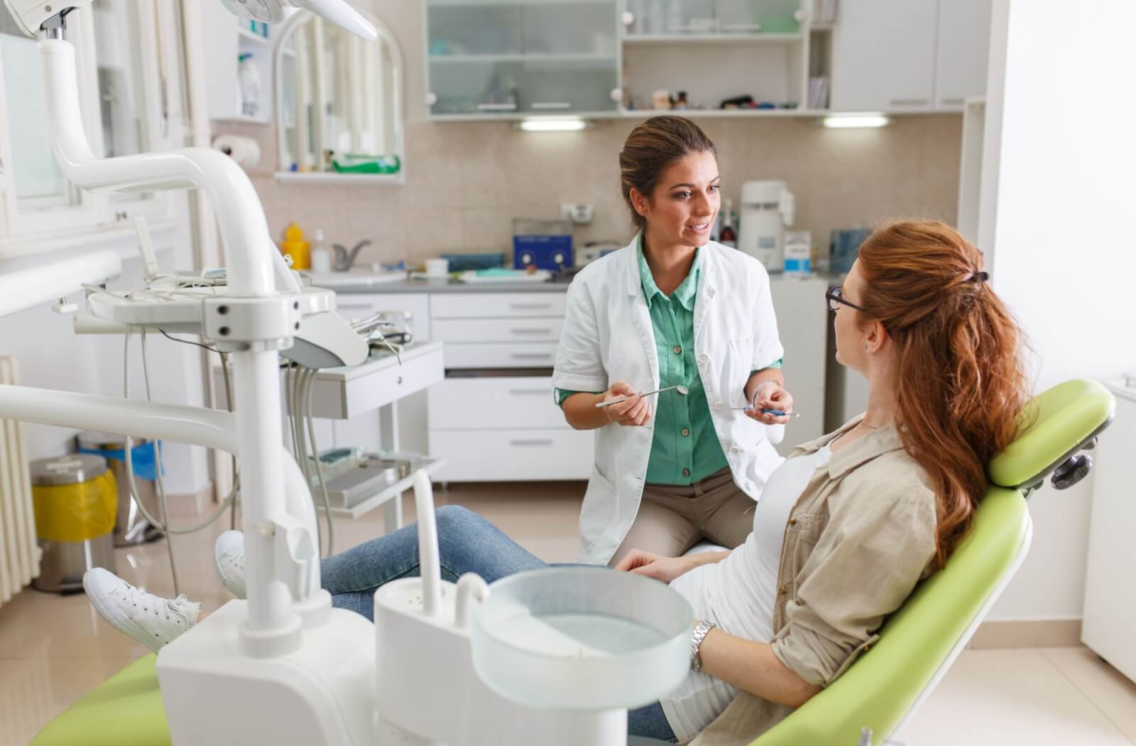 A dentist goes over their patient's dental implant placement options during an initial consultation.