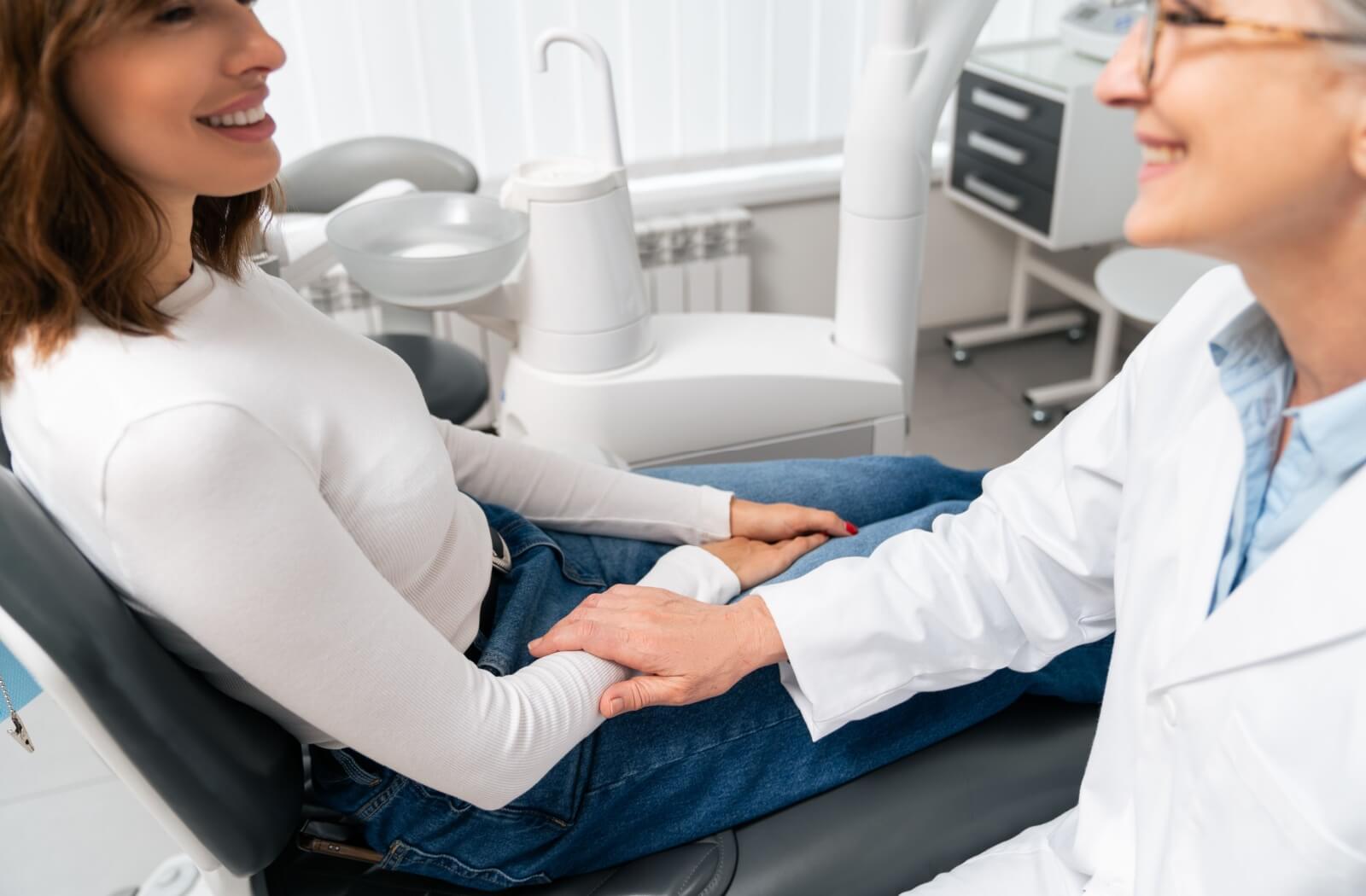 A dentist explains to a patient about their upcoming dental implant surgery, reassuring them